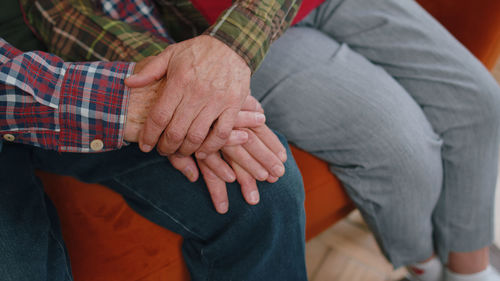 Low section of man sitting on sofa