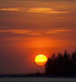 Scenic view of sea against romantic sky at sunset