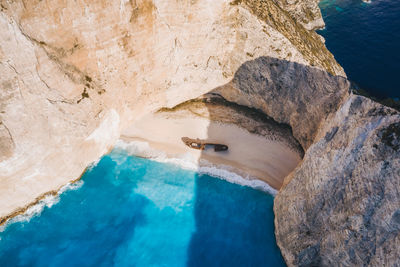 High angle view of woman on rock by sea