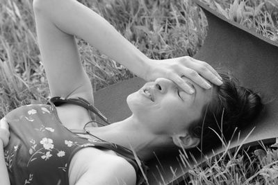 High angle view of smiling woman lying on grass