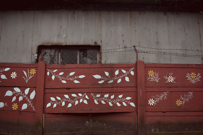 Painted wooden fence outside old building