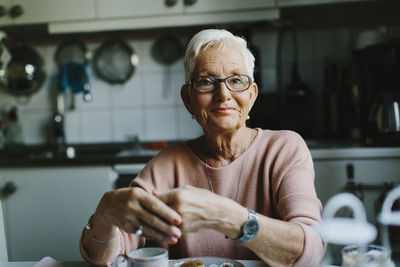 Portrait of woman sitting at home