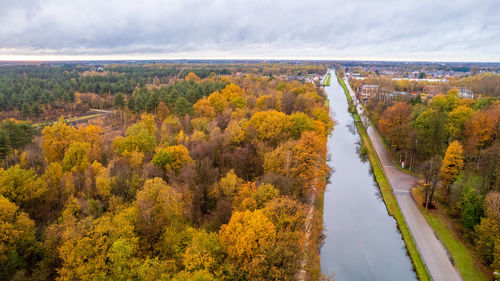 High angle view of road amidst trees against sky