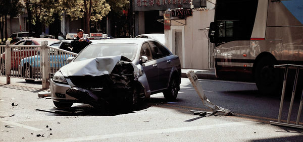 Man taking picture of damaged car