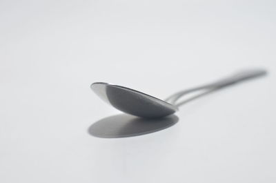 Close-up of wineglass against white background