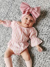 High angle view of cute baby girl sitting on floor