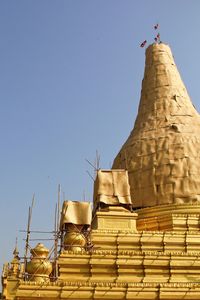 Low angle view of temple building against clear blue sky