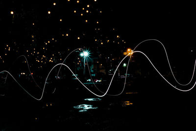 Light trails against sky at night