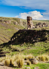 Built structure on landscape against sky