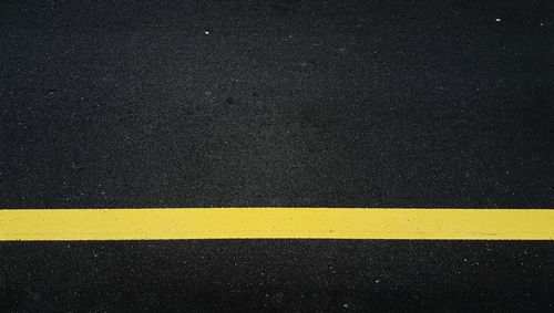 High angle view of yellow road sign on street