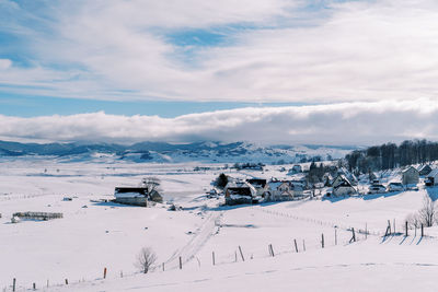 Scenic view of snow covered landscape against sky