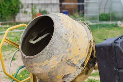 Close-up of rusty pipe on field