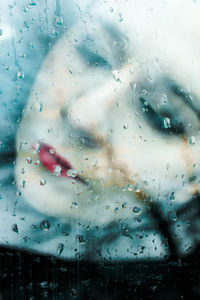 Woman seen through wet glass