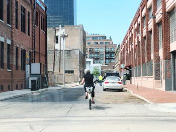 Man walking on street amidst buildings in city