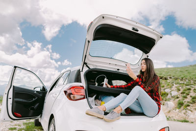 Rear view of man wearing warm clothing while sitting in car