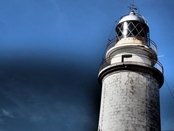 Low angle view of lighthouse against blue sky