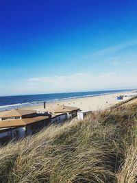 Scenic view of beach against blue sky