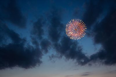 Low angle view of firework display at night