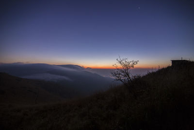 Silhouette of mountain against sky at dusk