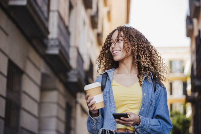 Young woman using mobile phone outdoors