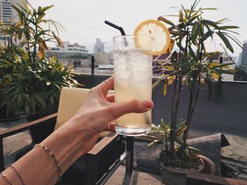 Hand holding cocktail drink