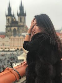 Midsection of woman standing in city