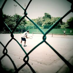 Children playing on chainlink fence