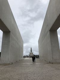 People on bridge against sky