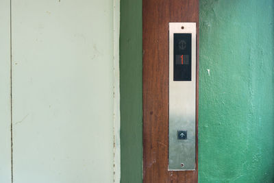 Close-up of control panel by elevator