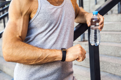 Midsection of man drinking water