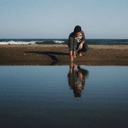 Woman standing by sea