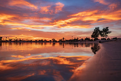 Scenic view of lake against orange sky