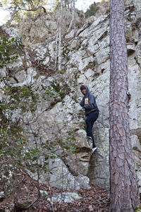 Side view of man on rock