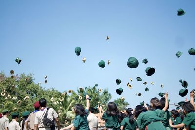 Students throwing hat in mid-air