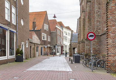 Street amidst buildings in city against sky