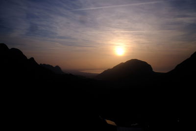 Scenic view of silhouette mountains against sky at sunset