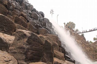 Low angle view of rock formation against sky
