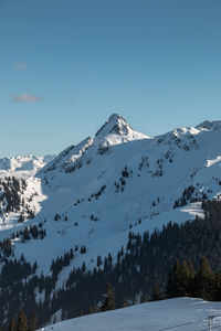 Scenic view of snowcapped mountains against clear sky