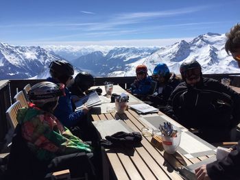 Tourists on snow covered mountain