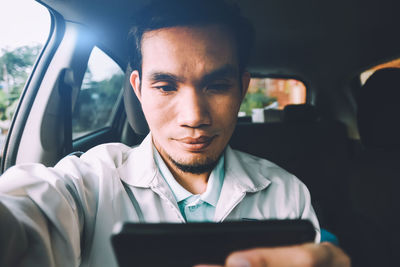 Portrait of young man using mobile phone