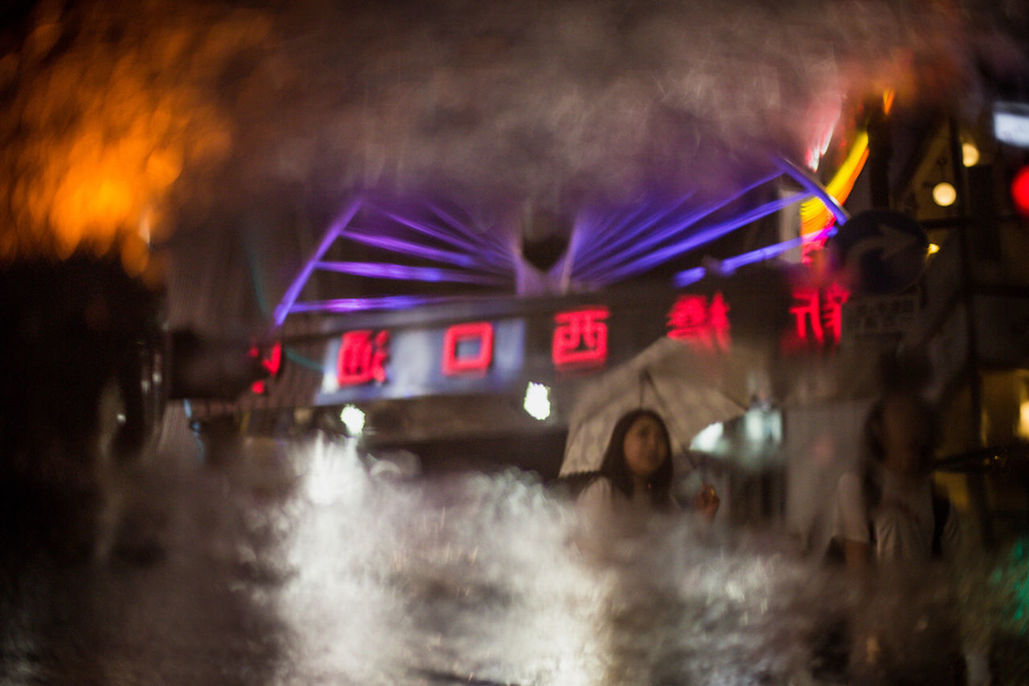 BLURRED MOTION OF CAR ON ILLUMINATED ROAD SIGN