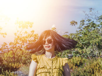 Portrait of beautiful woman against sky