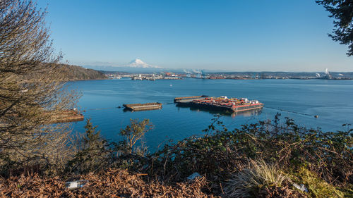 A view of the port of tacoma and mount rainier on a clear day.