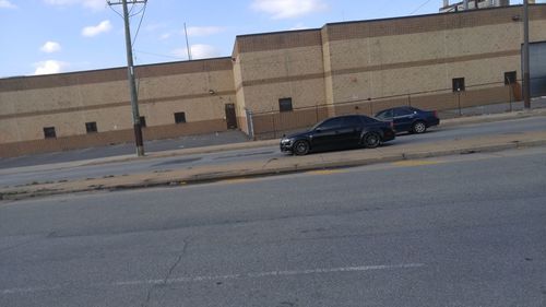 Vehicles on road along buildings