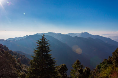 Scenic view of mountains against blue sky