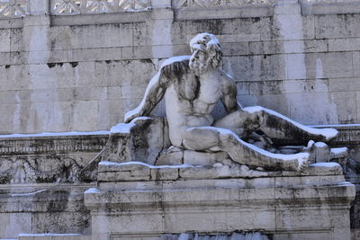 Low angle view of statue against building