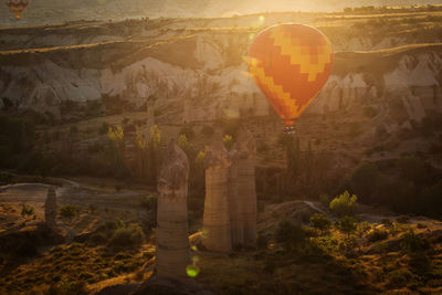 View of hot air balloon flying over rock