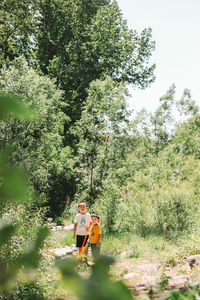 Rear view of man standing in forest