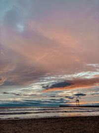 Scenic view of beach against sky during sunset