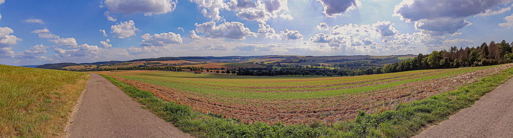 Panoramic shot of agricultural field against sky